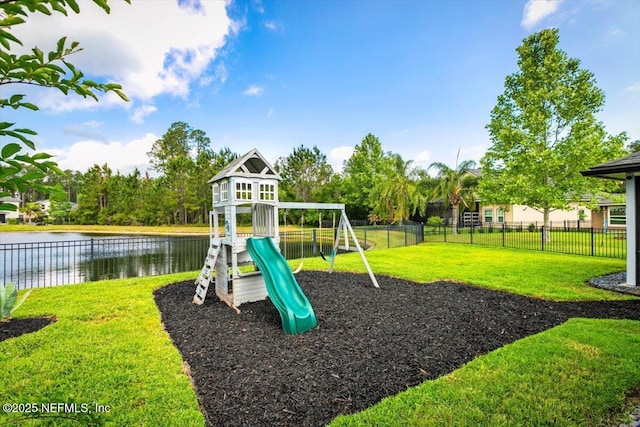view of playground featuring a water view, fence, and a yard