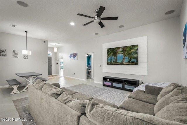 living room featuring baseboards, a ceiling fan, recessed lighting, and visible vents