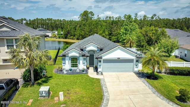 ranch-style home featuring concrete driveway, fence, a front lawn, and a garage