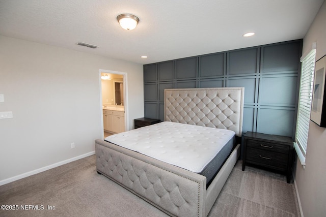 11213 Minnetta Ct, Jacksonville, FL 32256 - bedroom featuring visible vents, baseboards, recessed lighting, light carpet, and a decorative wall