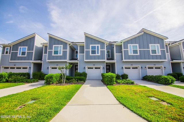 11213 Minnetta Ct, Jacksonville, FL 32256 - multi unit property with driveway, a front lawn, board and batten siding, and an attached garage