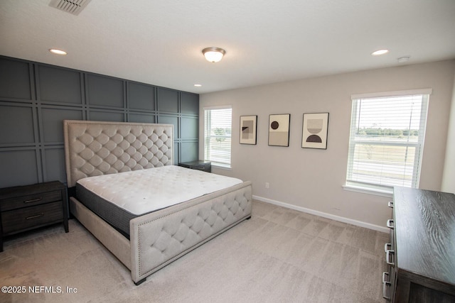 11213 Minnetta Ct, Jacksonville, FL 32256 - bedroom featuring visible vents, baseboards, recessed lighting, light carpet, and a decorative wall