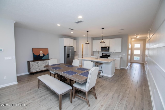 11213 Minnetta Ct, Jacksonville, FL 32256 - dining space featuring recessed lighting, visible vents, light wood-style flooring, and baseboards