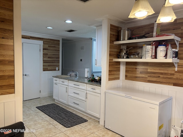 bathroom with wood walls, visible vents, tile patterned floors, and recessed lighting
