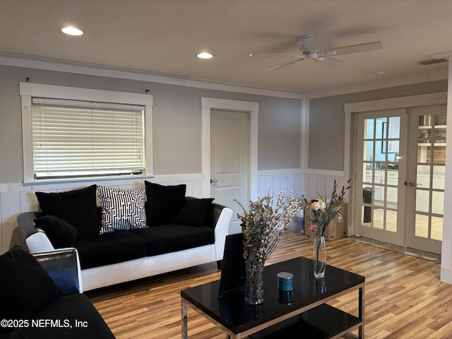 living room featuring recessed lighting, light wood-style floors, ceiling fan, wainscoting, and french doors