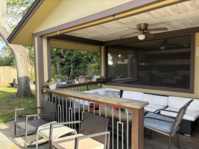 view of patio with a deck, fence, and a ceiling fan