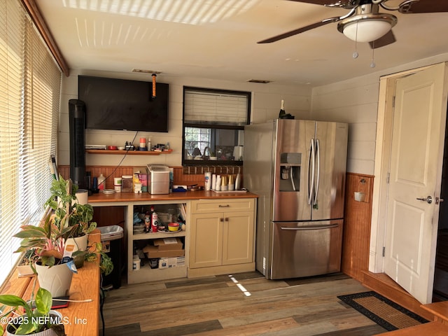 kitchen with a ceiling fan, wood counters, light wood-style flooring, and stainless steel fridge with ice dispenser