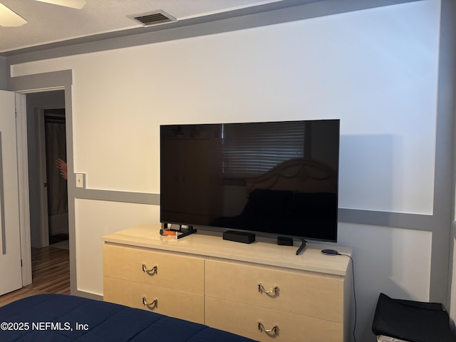 bedroom with visible vents and wood finished floors