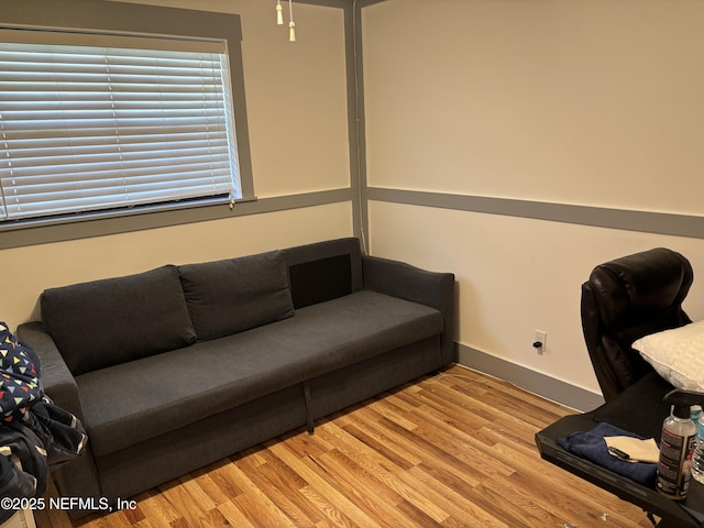 home office featuring wood finished floors and baseboards