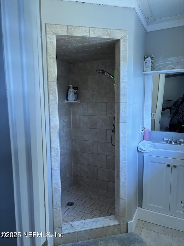 ensuite bathroom with tile patterned floors, a shower stall, ensuite bath, and vanity