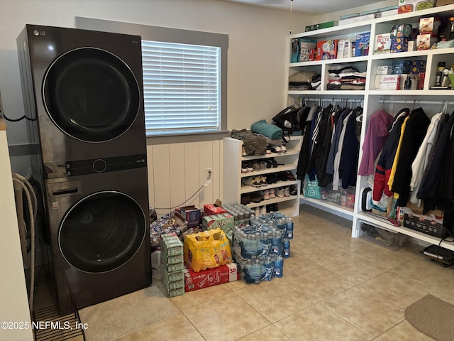 6050 Carrevero Dr S, Jacksonville, FL 32216 - laundry area with stacked washer and clothes dryer and tile patterned floors