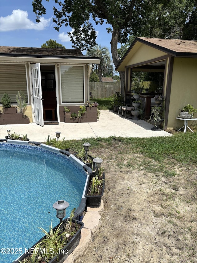 6050 Carrevero Dr S, Jacksonville, FL 32216 - swimming pool with a patio, an outdoor structure, and a storage structure