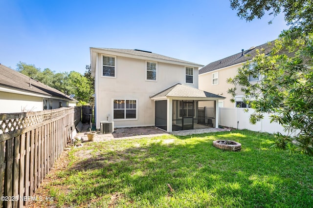 1821 Enterprise Ave, Saint Augustine, FL 32092 - rear view of property with a sunroom, an outdoor fire pit, stucco siding, roof with shingles, and central AC unit