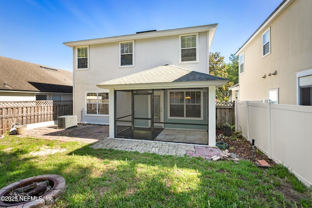 1821 Enterprise Ave, Saint Augustine, FL 32092 - back of house with a sunroom, a shingled roof, a patio, and central AC