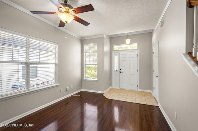 1821 Enterprise Ave, Saint Augustine, FL 32092 - foyer entrance with wood finished floors, ornamental molding, a ceiling fan, baseboards, and a textured ceiling