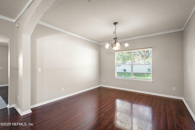 1821 Enterprise Ave, Saint Augustine, FL 32092 - spare room featuring a textured ceiling, dark wood-style floors, a chandelier, baseboards, and crown molding