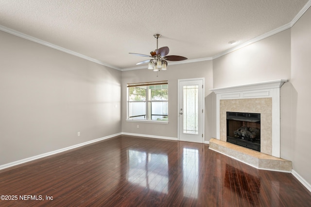1821 Enterprise Ave, Saint Augustine, FL 32092 - unfurnished living room with ceiling fan, a textured ceiling, dark wood finished floors, a tile fireplace, and baseboards