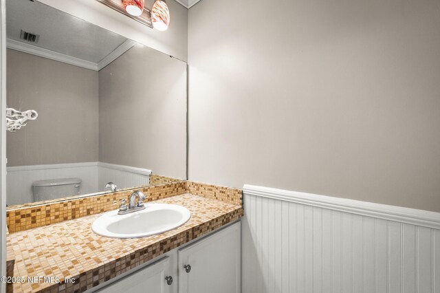 1821 Enterprise Ave, Saint Augustine, FL 32092 - bathroom featuring crown molding, vanity, and toilet