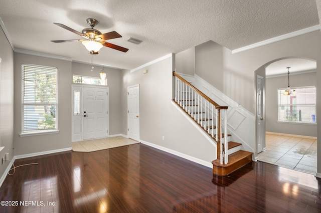 1821 Enterprise Ave, Saint Augustine, FL 32092 - entryway featuring wood finished floors, ornamental molding, arched walkways, a ceiling fan, and stairway