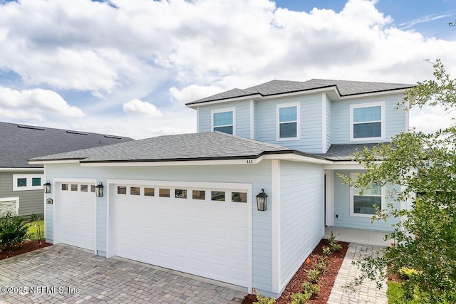 55 Iris Creek Dr, Saint Augustine, FL 32092 - view of front of property featuring a garage, decorative driveway, and a shingled roof