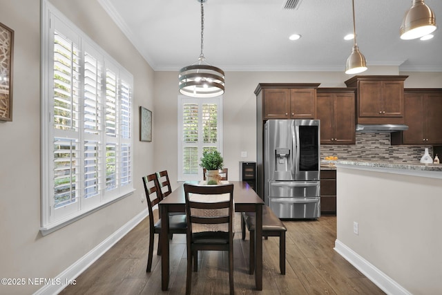 dining room featuring dark wood-style flooring, a chandelier, recessed lighting, and ornamental molding