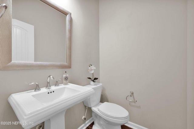bathroom with toilet and a sink