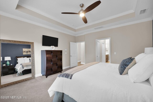 bedroom with ornamental molding, light colored carpet, visible vents, and a raised ceiling