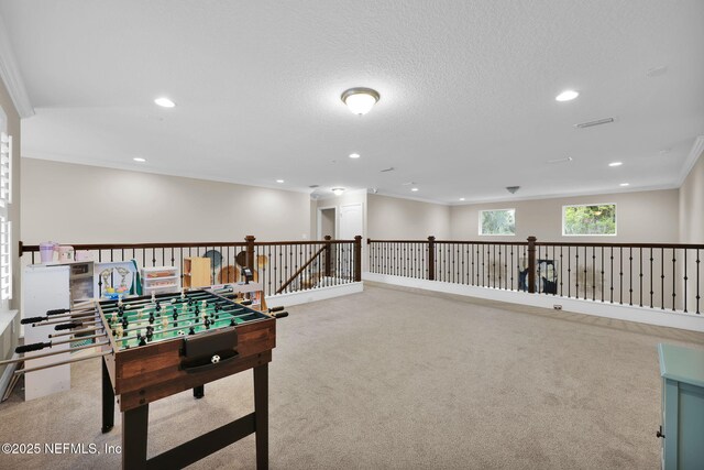 recreation room featuring crown molding, recessed lighting, and carpet