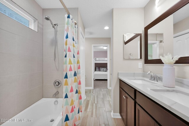 bathroom featuring recessed lighting, double vanity, shower / bath combo, a sink, and wood tiled floor