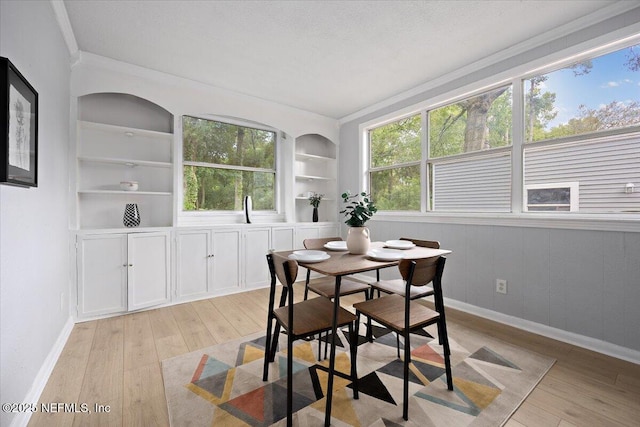 1232 Hamilton St, Jacksonville, FL 32205 - dining room with baseboards, light wood-type flooring, ornamental molding, and built in shelves