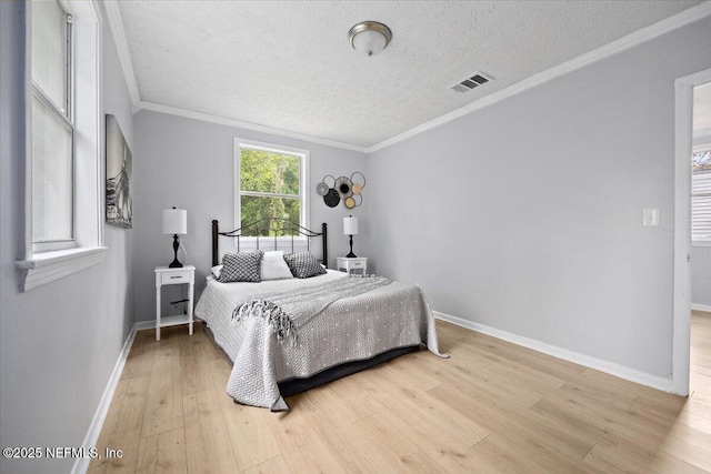 1232 Hamilton St, Jacksonville, FL 32205 - bedroom featuring a textured ceiling, visible vents, baseboards, and light wood-style floors