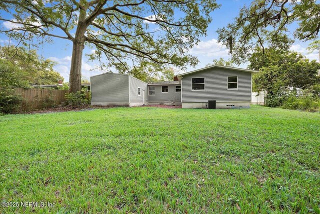 1232 Hamilton St, Jacksonville, FL 32205 - back of house with a lawn, central AC unit, and fence