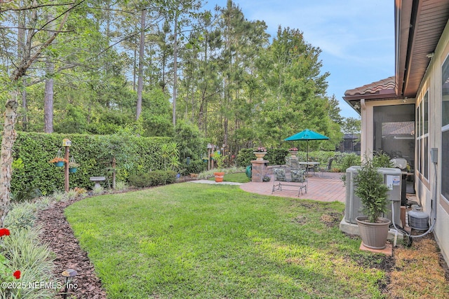 view of yard with a patio area and central air condition unit