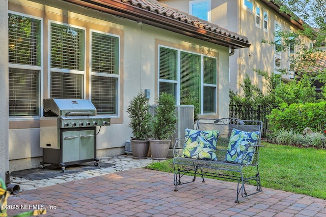 view of patio / terrace featuring a grill and fence
