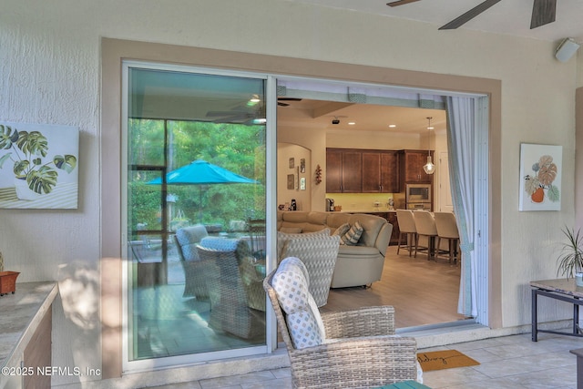 exterior space with stucco siding and ceiling fan