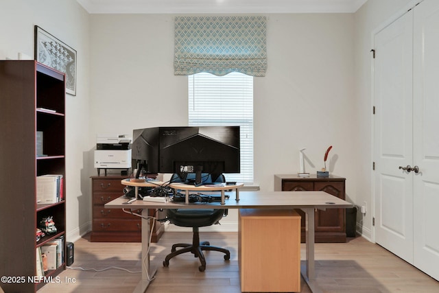 office area featuring light wood-type flooring and ornamental molding