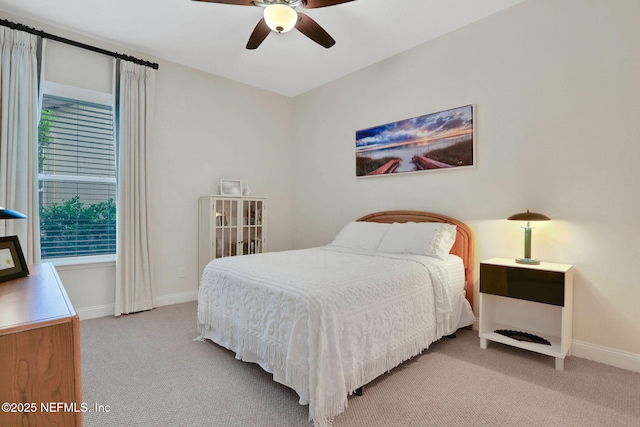 bedroom with light colored carpet, ceiling fan, and baseboards