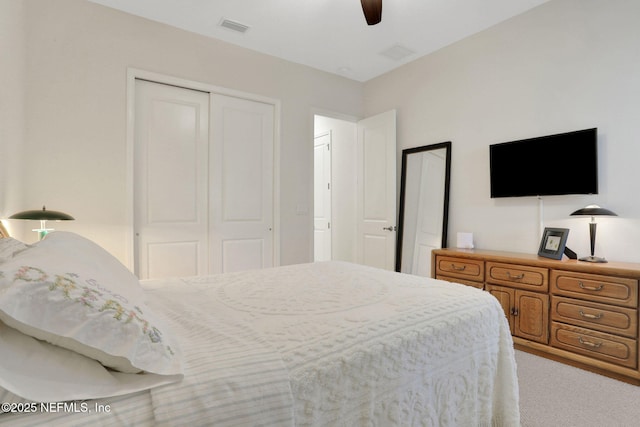 bedroom featuring visible vents, ceiling fan, carpet flooring, and a closet