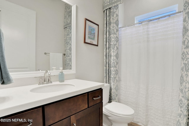 full bathroom with toilet and vanity