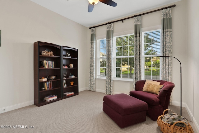 sitting room with baseboards, a ceiling fan, carpet flooring, and plenty of natural light