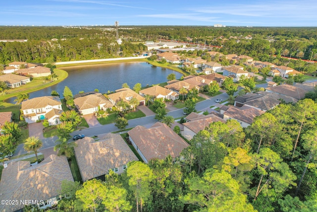 birds eye view of property with a water view, a forest view, and a residential view