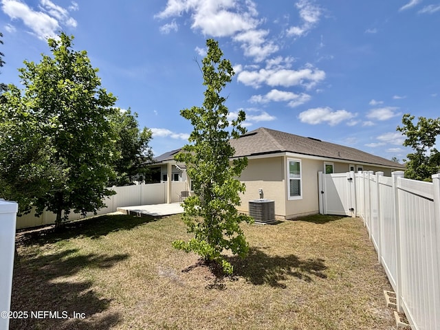 back of property featuring a lawn, a patio, a fenced backyard, and a gate