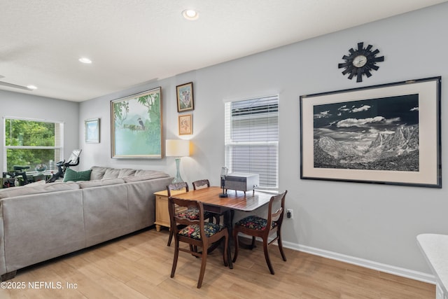 dining room featuring light wood finished floors, baseboards, and recessed lighting