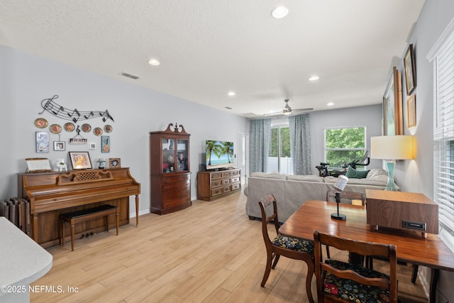 dining room with light wood finished floors, a ceiling fan, visible vents, and recessed lighting