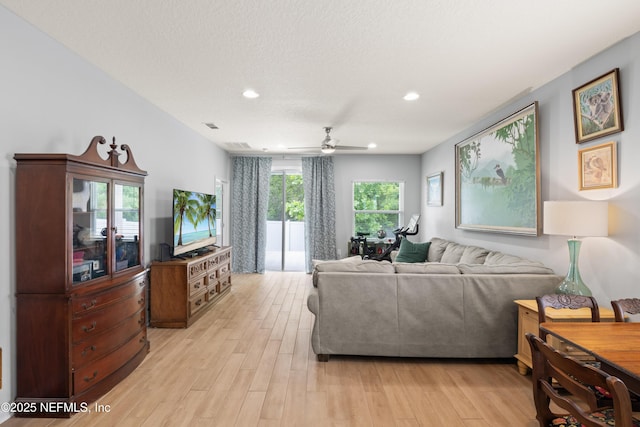 living room featuring ceiling fan, light wood-style flooring, and recessed lighting