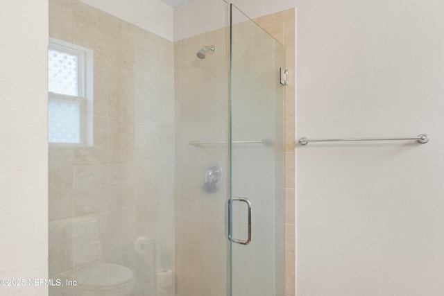 full bath with a shower stall and toilet