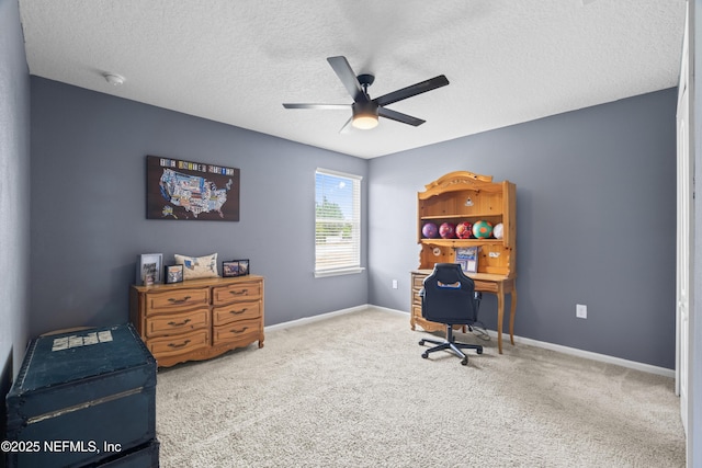 office featuring carpet, a textured ceiling, baseboards, and a ceiling fan