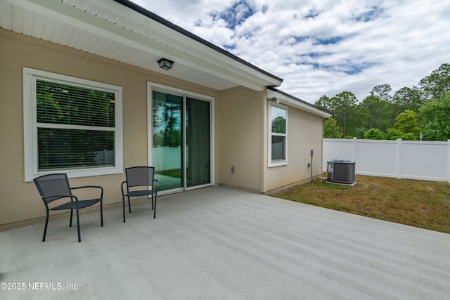 view of patio featuring cooling unit and fence