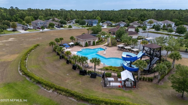 aerial view featuring a wooded view and a residential view