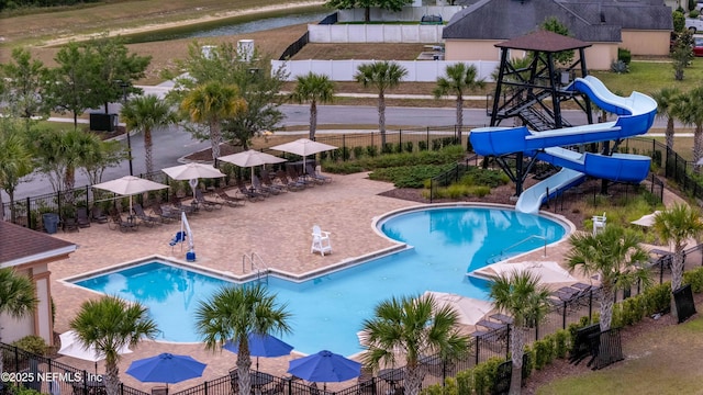 pool with a water slide and fence
